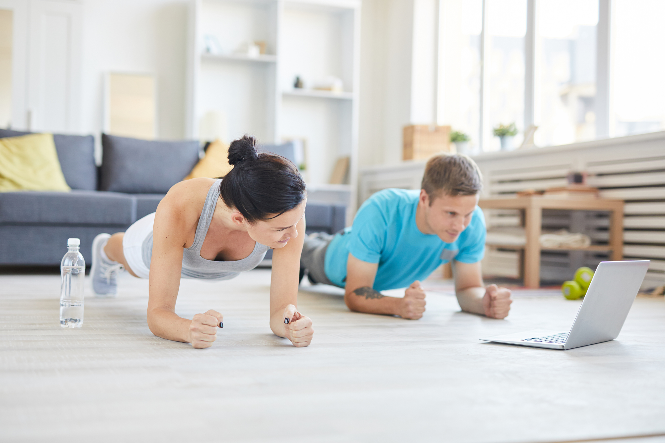 Man and woman working out in living room
