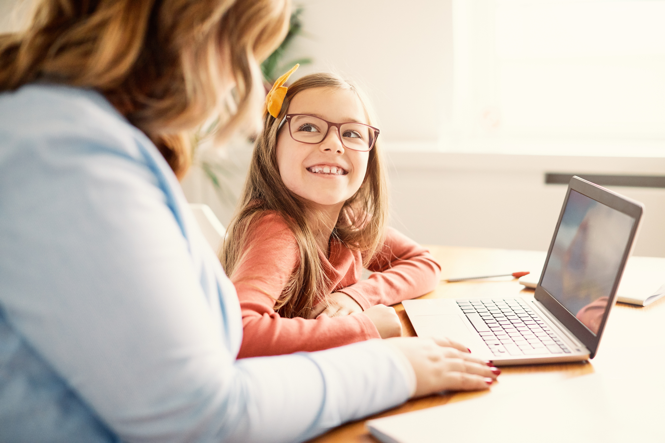 woman and young girl in front of laptop