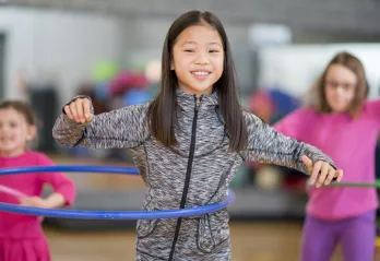 Holiday Camp 2021 hero image girl hula hoop