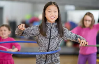 Holiday Camp 2021 hero image girl hula hoop